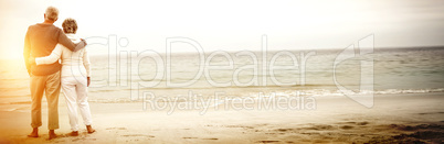 Rear view of senior couple embracing at beach Rear view of senior couple embracing at beach