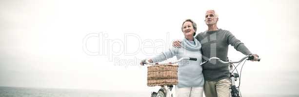 Happy senior couple with their bike