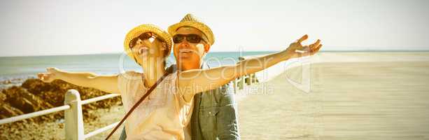 Happy casual couple going for a bike ride on the pier