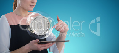 Composite image of businesswoman holding tablet computer