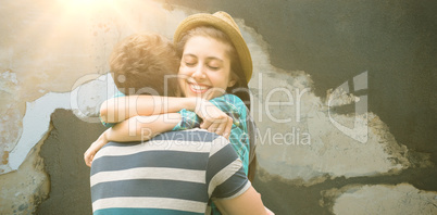 Composite image of couple hugging