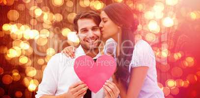 Composite image of pretty brunette giving boyfriend a kiss and her heart