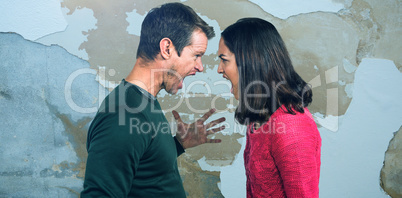 Composite image of side view of couple shouting standing face to face