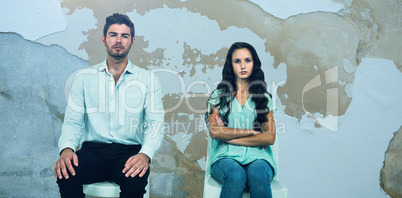Composite image of couple sitting on chairs not talking after argument