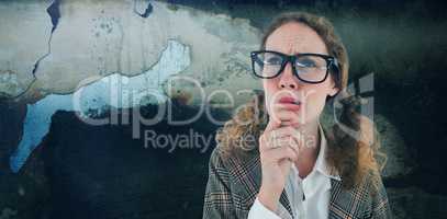 Composite image of geeky hipster woman thinking with hand on chin