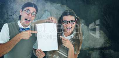 Composite image of geeky hipsters pointing at poster