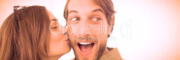 Woman kissing man with beard on cheek