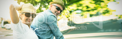 Happy mature couple going for a bike ride in the city