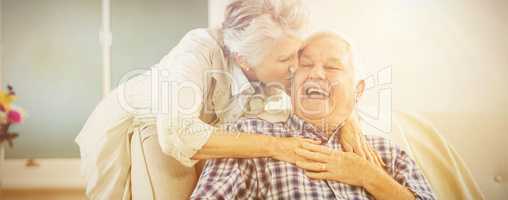 Senior woman embracing and kissing man