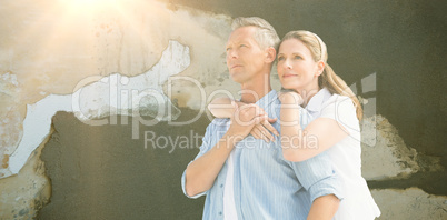 Composite image of mature couple embracing