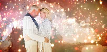 Composite image of side view of cute couple embracing each other