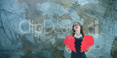 Composite image of geeky hipster holding a broken heart card