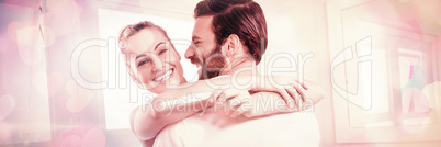 Woman holding pregnancy test while embracing man
