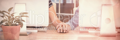 Couple working on computers and holding hands