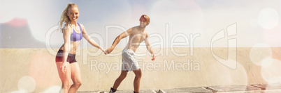 Fit couple rollerblading together on the promenade