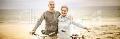 Happy senior couple with their bike