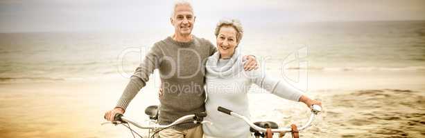 Happy senior couple with their bike