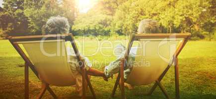 Happy mature couple sitting in park