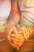 Cropped image of couple holding hands