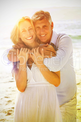 Happy couple hugging each other by the sea