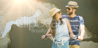 Composite image of man and woman cycling