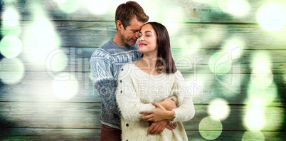 Composite image of romantic couple in warm clothing