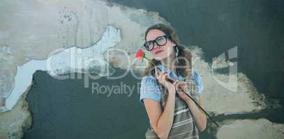 Composite image of geeky hipster woman holding rose