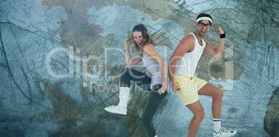 Composite image of geeky hipster couple posing in sportswear