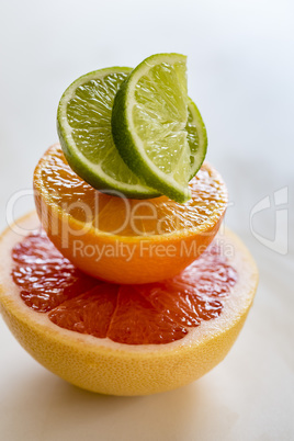 Colorful pile of half citrus fruit, top view, macro.