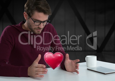 man with open hands and heart by office window