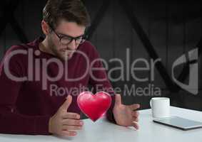 man with open hands and heart by office window