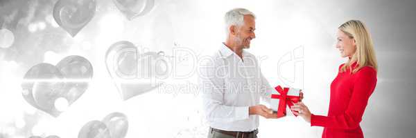 Valentines couple giving gift with love hearts background