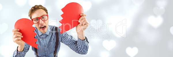 Valentines man breaking heart with love hearts background