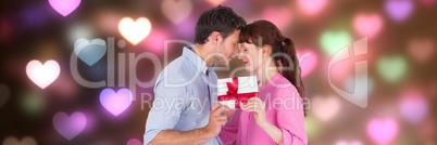 Valentines couple giving presents with love hearts background