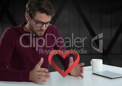 man with open hand and heart by office window