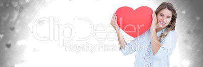 Valentines woman holding heart with love hearts background