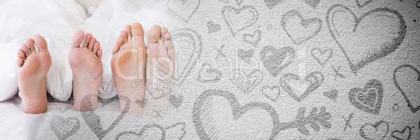 Couple's feet in bed with valentine's love transition hearts