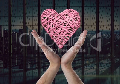 Woman with open hands and heart by office window