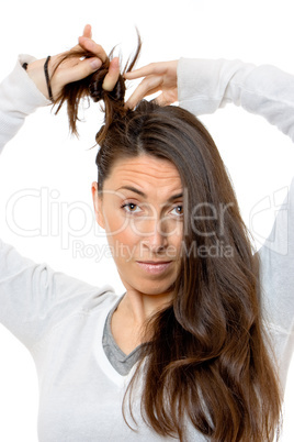 Beautiful young woman touching his hair