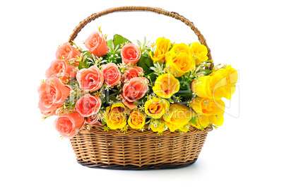 Silk red and yellow roses in a basket isolated on white backgrou