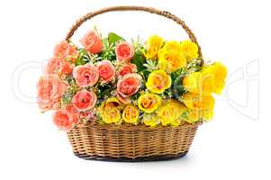 Silk red and yellow roses in a basket isolated on white backgrou