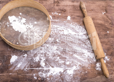 wheat flour sprinkled on a brown wooden table