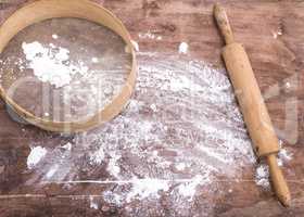 wheat flour sprinkled on a brown wooden table