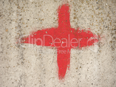 red cross on grey concrete texture background