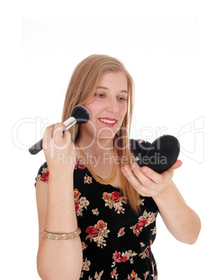 Beautiful woman putting on makeup