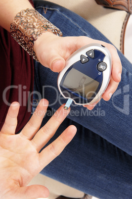 Woman testing her blood sugar