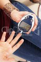 Woman testing her blood sugar