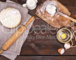 yeast dough in a wooden bowl, top view