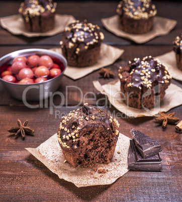 chocolate muffins on a brown wooden background