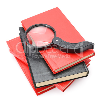 Large magnifier on book stack isolated on white.